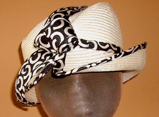 A spiffy hat with a split brim, trimmed with modern patterned silk.