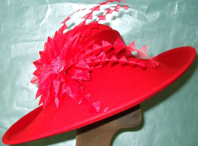 feather flower finishes the satin trim of this large gorgeous hat