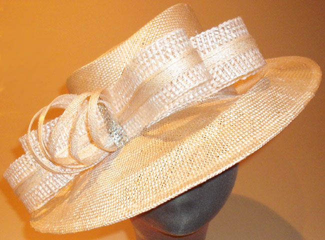 A sharp abaca straw doing a sculptured brim with a matching straw-braid double bow.