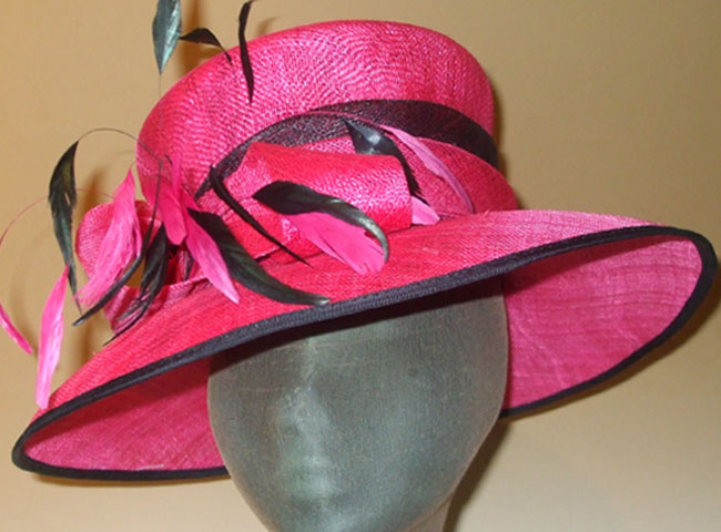 Try on this show-stopping multi-tiered sinamay hat with double-brim and feathers.